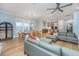 Open-concept living area showcasing hardwood floors, a fireplace, modern furniture, and a view into the kitchen at 2415 Jasper Patterson Dr, Johns Island, SC 29455