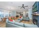 Open-concept living area showcasing a fireplace and TV feature with comfortable seating and a view into the modern kitchen at 2415 Jasper Patterson Dr, Johns Island, SC 29455