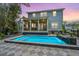 Stunning backyard pool with patterned tile surround, built-in waterfall feature, and a screened-in porch at 2415 Jasper Patterson Dr, Johns Island, SC 29455