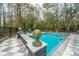 Tranquil backyard pool with patterned tile surround, framed by mature trees for added privacy at 2415 Jasper Patterson Dr, Johns Island, SC 29455