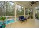 Relaxing screened porch with comfortable seating, offering serene views of the backyard pool and greenery at 2415 Jasper Patterson Dr, Johns Island, SC 29455