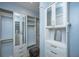Custom walk-in closet featuring drawers, shelves, mirrored cabinets and a comfy ottoman at 2415 Jasper Patterson Dr, Johns Island, SC 29455