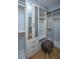Walk-in closet with custom shelving and cabinetry, complemented by a stylish ottoman at 2415 Jasper Patterson Dr, Johns Island, SC 29455