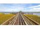 Scenic view from pier, highlighting a waterfront gazebo and tranquil blue waters under a partly cloudy sky at 2415 Jasper Patterson Dr, Johns Island, SC 29455