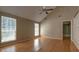 Bright living room featuring wood floors, tall windows, ceiling fan and access to upper level at 2612 Morning Dove Ln, Charleston, SC 29414