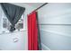 Clean bathroom features a shower with modern white tile and contrasting red and black shower curtains at 2671 Houston St, North Charleston, SC 29405