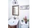 Cozy bathroom with single sink vanity, decorative mirror, and charming decor at 2671 Houston St, North Charleston, SC 29405
