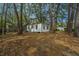 Quaint single-story home with large trees on a leaf-covered yard at 2671 Houston St, North Charleston, SC 29405