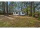 Cozy home nestled among mature trees, showcasing a well-maintained lawn at 2671 Houston St, North Charleston, SC 29405
