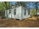 Exterior view of a one-story building with white siding and black framed windows at 2671 Houston St, North Charleston, SC 29405