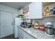 Bright kitchen features white cabinets, granite countertops, stainless steel sink, and modern KitchenAid mixer at 2671 Houston St, North Charleston, SC 29405