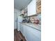 Well-lit kitchen features white cabinets, granite countertops, stainless steel sink, and updated appliances at 2671 Houston St, North Charleston, SC 29405