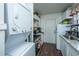 Updated kitchen with stacked washer/dryer, modern appliances, white cabinets, and granite countertops at 2671 Houston St, North Charleston, SC 29405