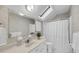 Bright bathroom featuring a skylight, vanity, and a shower with decorative wallpaper at 30 Hunters Forest Dr, Charleston, SC 29414