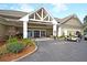 Clubhouse exterior with covered entrance, manicured landscaping, and convenient parking for golf carts at 30 Hunters Forest Dr, Charleston, SC 29414