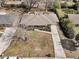 Overhead shot of a well-maintained property with a long driveway, manicured lawn, and mature trees in a quiet neighborhood at 303 Gippy Dr, Summerville, SC 29486