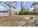 Spacious backyard featuring a fire pit, wooden fence, sheds, and large trees, perfect for outdoor gatherings and relaxation at 303 Gippy Dr, Summerville, SC 29486