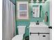 Bathroom with teal walls, a sleek vanity with barn doors, and tiled shower at 303 Gippy Dr, Summerville, SC 29486