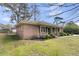 A charming brick house featuring a cozy porch with rocking chairs and updated landscaping enhancing its curb appeal at 303 Gippy Dr, Summerville, SC 29486
