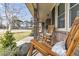Inviting front porch with wooden rocking chairs, comfortable cushions, and a view of the landscaped yard at 303 Gippy Dr, Summerville, SC 29486