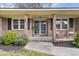 Inviting front porch with rocking chairs, brick columns, and a view of the landscaped yard at 303 Gippy Dr, Summerville, SC 29486