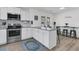Well-equipped kitchen with white cabinets, stainless steel appliances, granite countertops, and a dining table at 303 Gippy Dr, Summerville, SC 29486