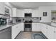 Modern kitchen with white cabinets, stainless steel appliances, granite countertops, and subway tile backsplash at 303 Gippy Dr, Summerville, SC 29486