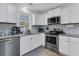 Well-lit kitchen with white cabinets, stainless steel appliances, granite countertops, and subway tile backsplash at 303 Gippy Dr, Summerville, SC 29486