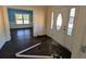 View of the entryway showcasing the front door, damaged floors, and adjoining rooms at 305 Sandridge Rd, Dorchester, SC 29437
