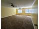 Spacious living room features neutral carpeting, dual ceiling fans, and an abundance of natural light from the windows at 305 Sandridge Rd, Dorchester, SC 29437