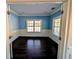 Home office with light blue walls, white trim, hardwood floors, and two large windows at 305 Sandridge Rd, Dorchester, SC 29437