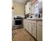 Vintage kitchen featuring white cabinets, an oven, and a sink under the window at 306 Perry Rd, Walterboro, SC 29488