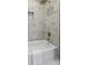 Bathtub with a shower head and tiled walls at 313 Runnymede Ln, Summerville, SC 29485
