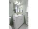Bathroom featuring a white vanity with brass fixtures, a framed mirror, and decorative accessories at 313 Runnymede Ln, Summerville, SC 29485