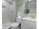 Bright bathroom featuring a tiled walk-in shower and modern vanity with brass fixtures and decorative mirror at 313 Runnymede Ln, Summerville, SC 29485