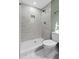 Modern bathroom featuring a tiled walk-in shower with a rainfall showerhead and decorative tiling at 313 Runnymede Ln, Summerville, SC 29485