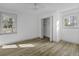 Spacious bedroom featuring neutral walls, wood-look flooring, and a large window at 313 Runnymede Ln, Summerville, SC 29485