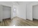 Bright bedroom featuring neutral walls, wood-look flooring, and a closet at 313 Runnymede Ln, Summerville, SC 29485