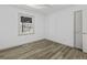 Bedroom with neutral walls and wood-look flooring, showcasing a window and closet at 313 Runnymede Ln, Summerville, SC 29485