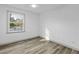 Well-lit bedroom with neutral walls, wood-look flooring, and a window at 313 Runnymede Ln, Summerville, SC 29485