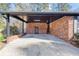 Spacious brick carport featuring a concrete floor and convenient access to the home at 313 Runnymede Ln, Summerville, SC 29485