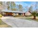 Charming brick home with a well-manicured lawn and driveway, showcasing its curb appeal at 313 Runnymede Ln, Summerville, SC 29485