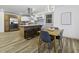 Eat-in kitchen boasts stainless appliances, granite countertops, island seating, and modern lighting at 313 Runnymede Ln, Summerville, SC 29485