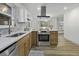 Updated eat-in kitchen features stainless appliances, a neutral backsplash, and a view at 313 Runnymede Ln, Summerville, SC 29485