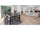 Open-concept living and dining area with light wood floors and bright, airy ambiance at 313 Runnymede Ln, Summerville, SC 29485