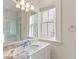Bathroom vanity featuring granite countertops, tile floors, and a large mirror at 32 Prioleau St # N, Charleston, SC 29401