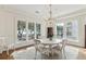 Elegant dining room with chandelier and waterfront views through large windows at 32 Prioleau St # N, Charleston, SC 29401