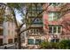 Brick condo building with balconies and street view featuring tree and well maintained landscaping at 32 Prioleau St # N, Charleston, SC 29401