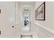Long hallway with high ceilings and trim, leading to a living room with waterfront views at 32 Prioleau St # N, Charleston, SC 29401