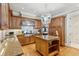 A kitchen featuring wood cabinets, an island with granite countertop, and stainless steel appliances at 32 Prioleau St # N, Charleston, SC 29401